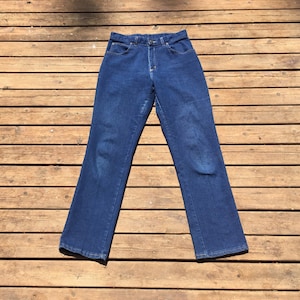 May include: A pair of dark blue denim jeans with a straight leg fit.
