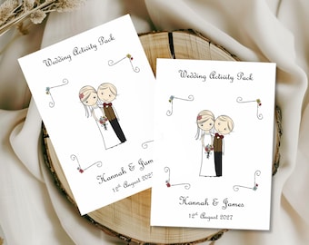 May include: Two white rectangular wedding activity pack cards featuring a cartoon illustration of a bride and groom. The text reads Wedding Activity Pack, Hannah & James, and 12th August 2027. A label at the bottom indicates A6 Size Pack.