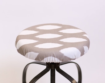 May include: A grey and white patterned fabric stool cover. The cover is made of a soft, comfortable fabric and is perfect for adding a touch of style to any stool.