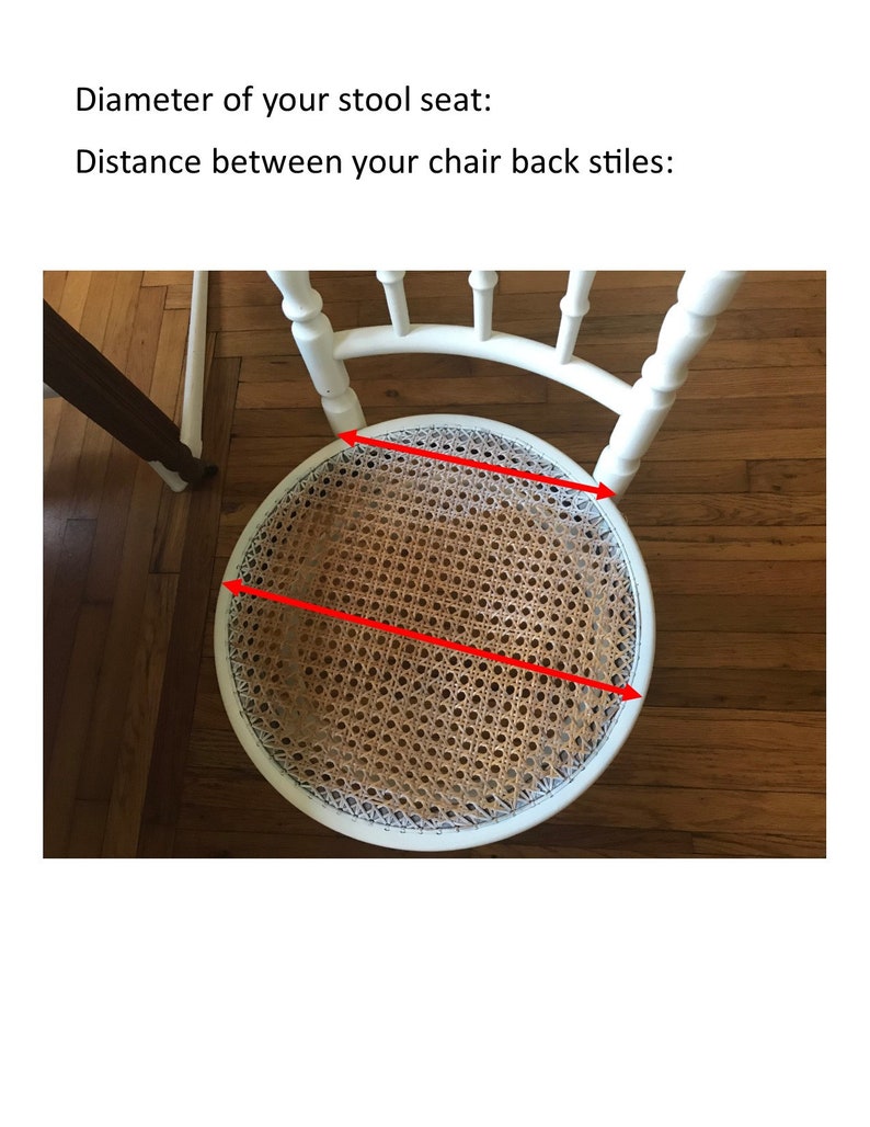 May include: White chair with a woven cane seat. The seat is marked with red lines to show the diameter of the seat.