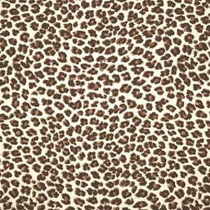 May include: A brown and white leopard print fabric with a repeating pattern of brown spots on a white background.