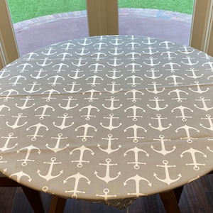 Round Outdoor Fitted Tablecloth. Soil and Stain Resistant. Washable. Select from elastic or drawstring.  Sailor Grey with White Anchors