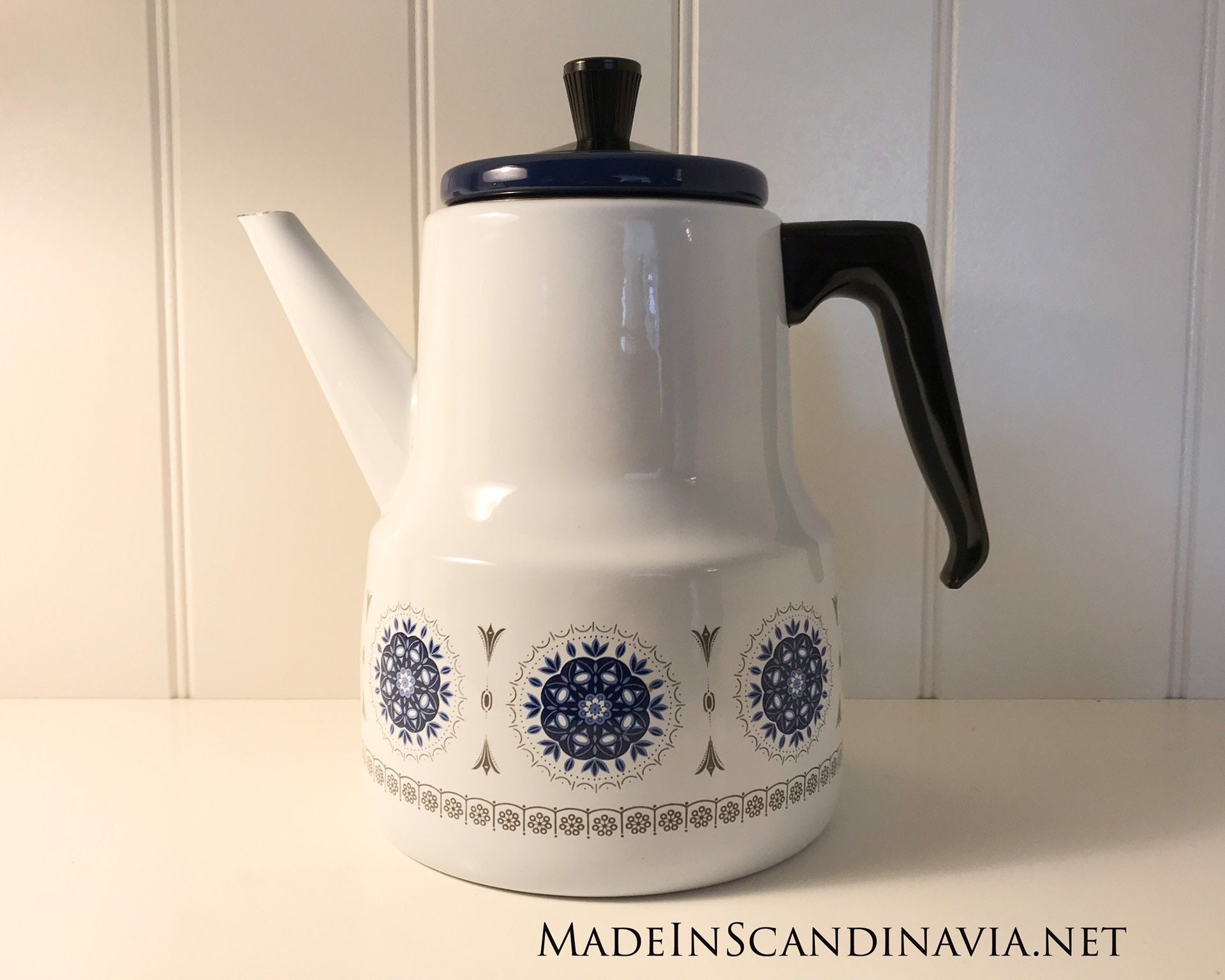 Vintage coffee pot in white and blue enamel