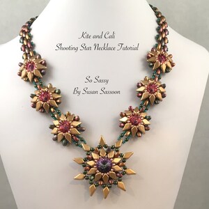 May include: A beaded necklace with a starburst design. The necklace features gold-colored beads, with pink and purple accents. The text "Kite and Cali Shooting Star Necklace Tutorial" and "So Sassy By Susan Sassoon" is visible.
