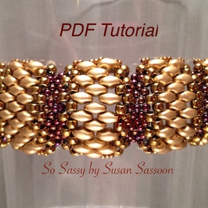 May include: A gold and brown beaded bracelet with a geometric pattern. The bracelet is labelled "So Sassy by Susan Sassoon" and "PDF Tutorial".