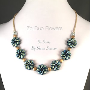 May include: A gold chain necklace with blue and green flower-shaped beads. The necklace is labeled "ZoliDuo Flowers So Sassy By Susan Sassoon".