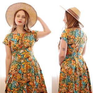 Vintage mustard yellow tiki tropical Hawaiian inspired floral short sleeve fitted bodice pleated skirt knee length sundress sun dress