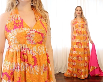 May include: A long, orange and pink halter dress with a floral pattern and silver accents. The dress has a fitted bodice and a flowing skirt.