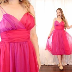 May include: A pink and magenta ombre sleeveless dress with a V-neckline and a gathered waist.