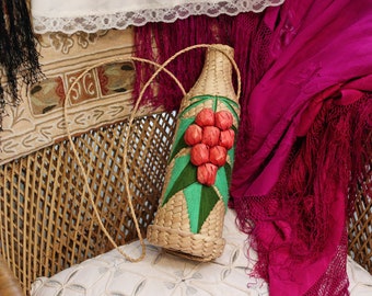 1960s Vintage Mexican hand-woven straw wine bottle carrier with strap decorated with pink grapes and embroidered leaves kitsch kitchen decor