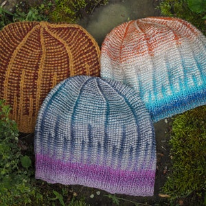 May include: Three knitted hats in different color gradients. The first hat is a brown and orange gradient, the second is a blue and white gradient, and the third is a purple and blue gradient.