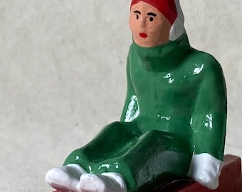 Seated Woman Sledder with sled, Christmas Village, winter train layout, hand-painted vintage toy reproduction