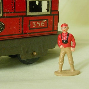 Little boy with camera, O scale tinplate model railroad train layout, hand-painted reproduction of vintage toy figure