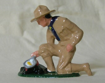 Boy Scout Cooking Eggs over a Campfire, collectible figurine, hand-painted reproduction of vintage/antique toy figure