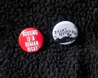 2-Pack of Housing Crisis/Tenant Union Pins - 1 1/4 inch pin back button pack - 2 housing activists pins by Montreal artist Tricia Robinson