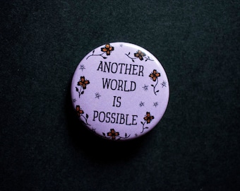 Another World is Possible -  Pin/Badge - 1 1/2 inch pin back button - statement button - revolutionary pins - a better future