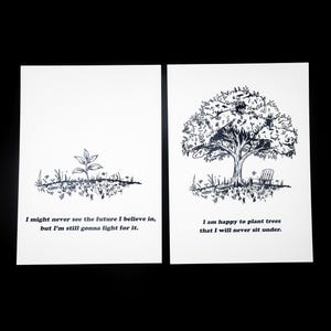 May include: Two white rectangular prints with black ink illustrations. The left print shows a small sprout with the text: I might never see the future I believe in, but I'm still gonna fight for it. The right print shows a large tree with a chair.