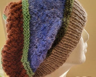 A textured, cozy-soft bohemian beanie inspired by the colors of woodland wildflowers. It is hand knit, all wool
