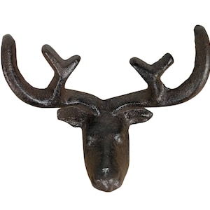 May include: A dark brown cast iron deer head wall hook. The hook has detailed antlers and a textured surface. This decorative item is suitable for a rustic or cabin-themed decor.