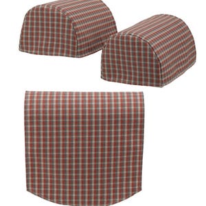 May include: Set of three red, white, and gray plaid armrest covers. The covers are shaped like a half-cylinder and have a rounded edge.