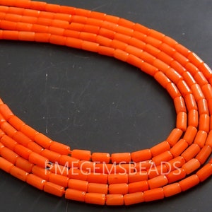 May include: Multiple strands of bright orange cylindrical beads arranged in a curved formation. The beads are uniform in shape and size, featuring a smooth, matte finish. The text PMEGEMSBEADS is visible in white lettering across the center.