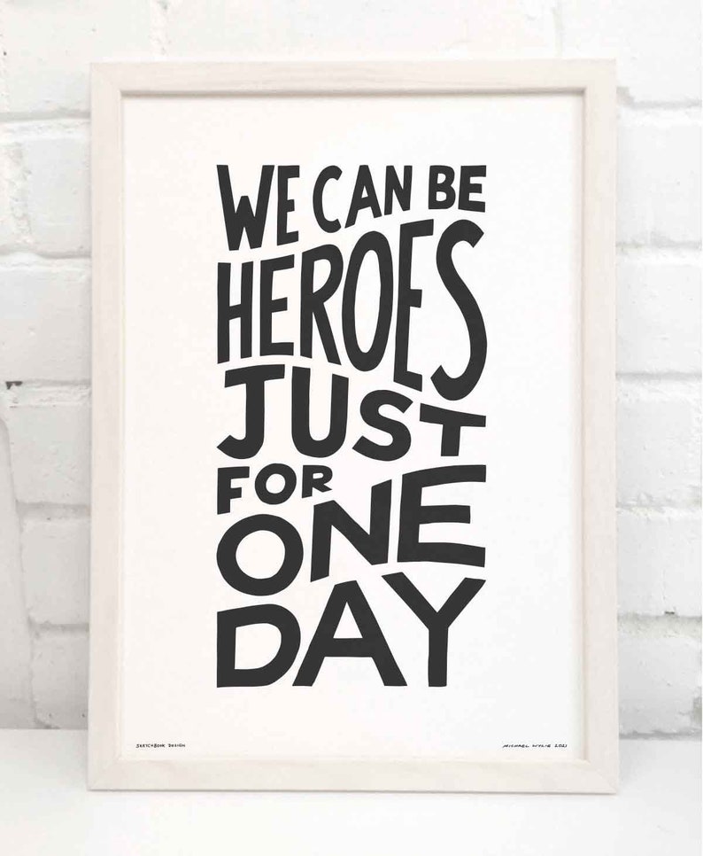 Op de afbeelding: Zwart-wit typografieprint met de tekst "We can be heroes just for one day".