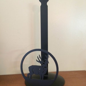 May include: Black metal paper towel holder with a deer silhouette design.