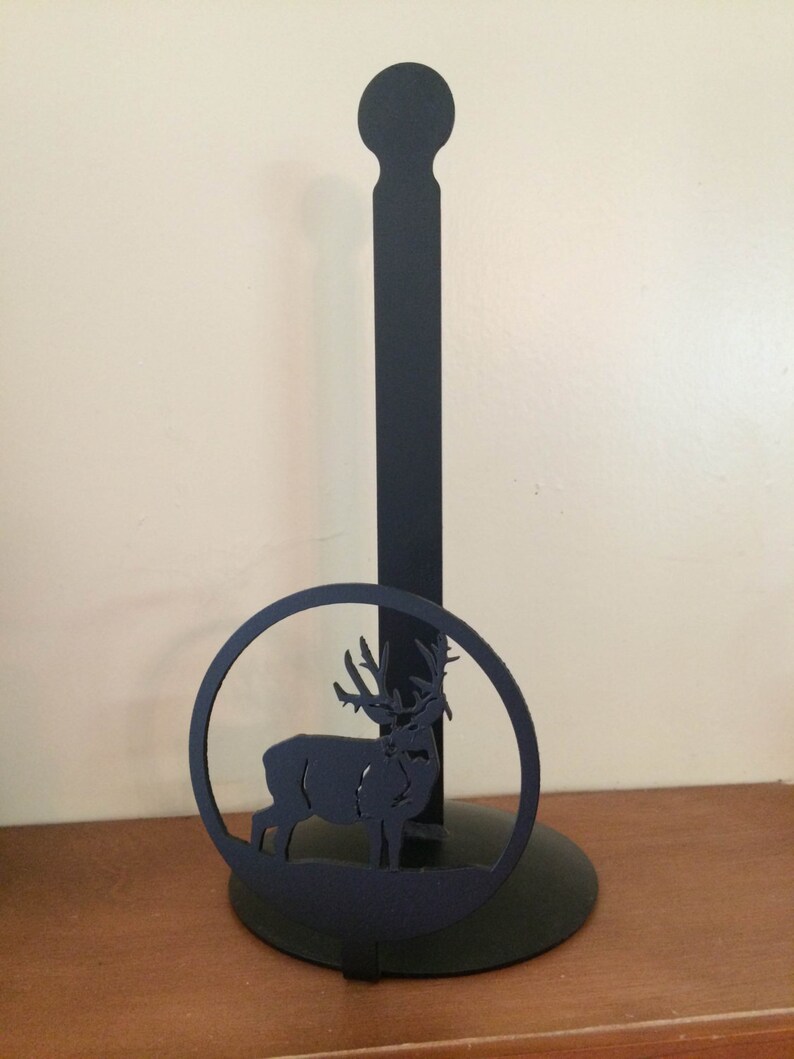 May include: Black metal paper towel holder with a deer silhouette design.