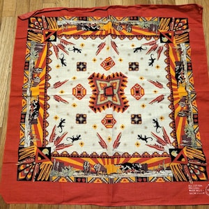 May include: Square, red and cream-colored bandana with a Southwestern design. The center features geometric patterns, lizards, and feathers. The border is red with a repeating pattern. The bandana is made of cotton.