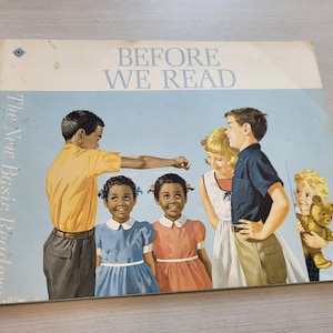 May include: Vintage book cover titled "Before We Read" featuring illustrations of children. The cover has a light blue background with the title in white. The illustration shows children of different ethnicities.