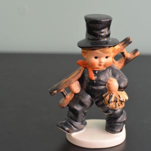 May include: A set of three ceramic mugs with a speckled, matte finish. Each mug features a different color: light blue, cream, and gray. The mugs have a simple, modern design and a comfortable handle.