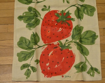 May include: A white tea towel with a red and green print of strawberries and leaves. The text "Virao" is printed in the bottom right corner.