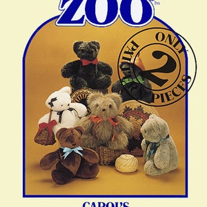 May include: A collection of five plush teddy bears in various colors and styles, including brown, black, gray, and white. The bears are arranged on a tan background with a woven basket and a ball of yarn. The image includes the text "CAROL'S ZOO" and "CAROL'S BEARRIT".
