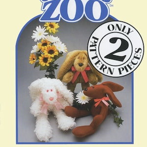 May include: Carol's Zoo pattern for a skinny bunny plush toy. The pattern includes two pieces and features a white bunny with pink accents, a brown bunny with red accents, and a brown bunny with red accents. The pattern is illustrated with a photo of the finished plush toys.