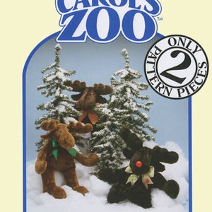 May include: A pattern for making a moose plush toy. The pattern is from Carol's Zoo and is only two pieces. The image shows a brown moose plush toy in a snowy forest setting.
