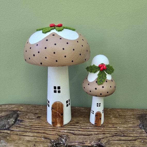 A handmade wooden Christmas pudding that's secretly a toadstool fairy house — two whimsical concepts colliding in one tiny object, 103 favorites don't lie.