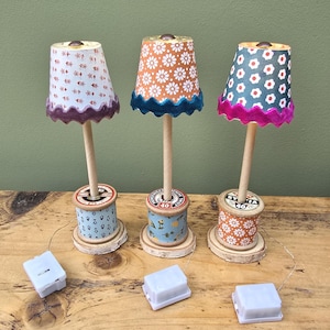 Handmade miniature table lamp with vintage wooden bobbin base, fairy lights and patterned shade. Dollhouse decor battery powered light.