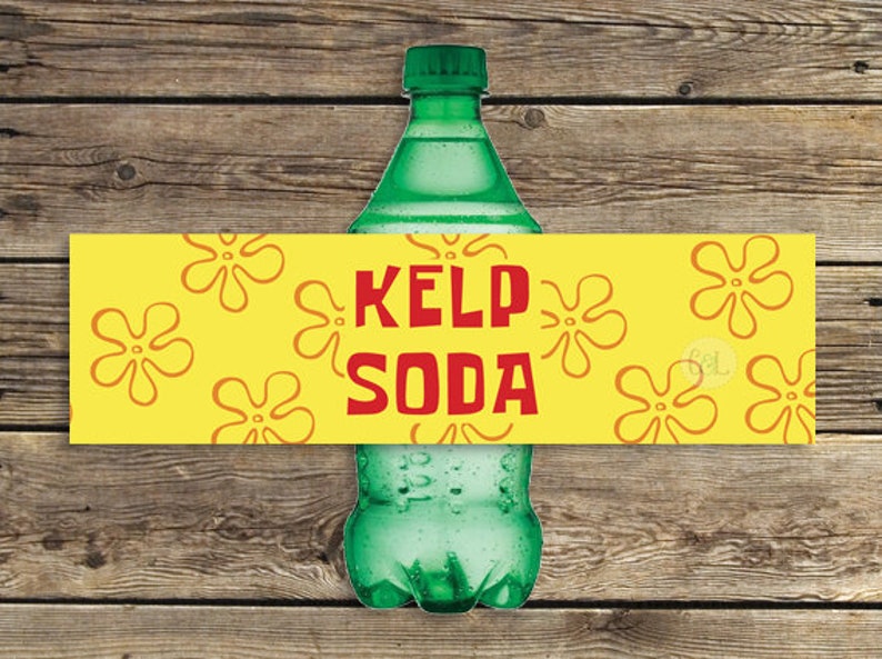 May include: A green glass bottle with a yellow label that says "Kelp Soda". The label has a pattern of yellow flowers on a yellow background.