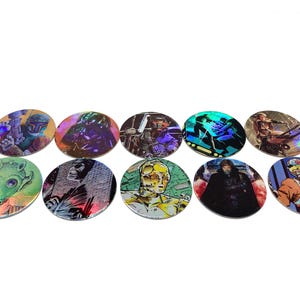 May include: A collection of ten oval-shaped Star Wars character trading cards. The cards feature various characters in vibrant colors and holographic effects. The characters include Darth Vader, C-3PO, and others from the Star Wars franchise.