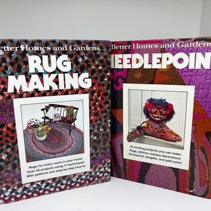 May include: Two Better Homes and Gardens craft books titled Rug Making and Needlepoint. The Rug Making cover features a braided rug and bench. The Needlepoint cover displays a colorful lion-shaped pillow and lists various project types.