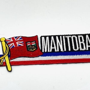 May include: An embroidered patch with the Canadian flag and the word "MANITOBA" in white lettering on a black background. The patch has a red, white, and blue striped border.