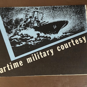 May include: A vintage print with a black background and a blue and white illustration of a warship at sea. The text "wartime military courtesy" is printed in white across the bottom of the print.