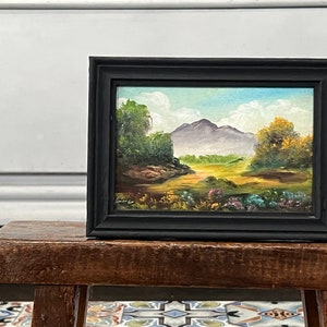 small vintage oil painting of a mountain and flowery field on a sunny day, 5x7 inches framed