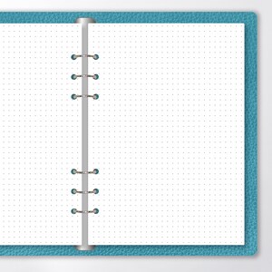 May include: A blue leather bound notebook with a white dotted page open. The notebook has a silver ring binder.