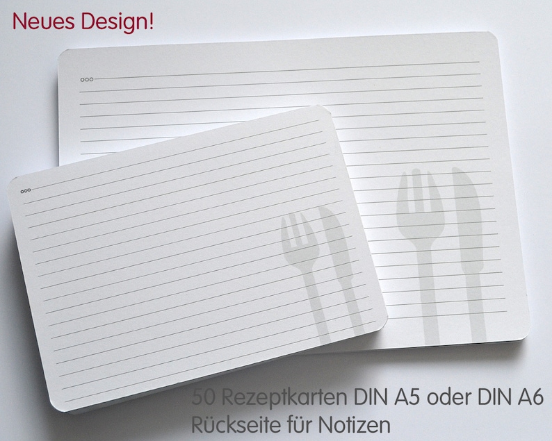 May include: A stack of 50 white recipe cards with lined paper and a gray fork and knife design. The text on the cards reads "50 Rezeptkarten DIN A5 oder DIN A6 R&uuml;ckseite f&uuml;r Notizen".