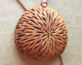 Hand carved avocado stone necklace, natural jewelry. Abstract carved design.