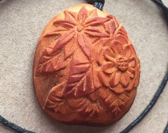 Hand carved avocado stone pendant with flowers. Unique and beautiful :)