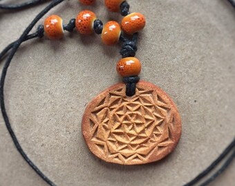 Carved avocado pit necklace with ceramic beads|