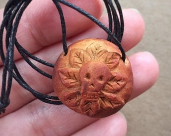 Hand carved avocado pit necklace with a skull. Unique, beautiful, natural. Sugar skull.