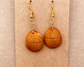 Earrings made with avocado pits.